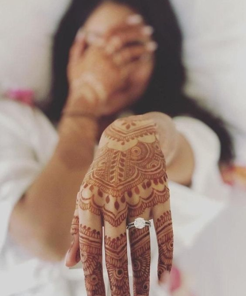 Showing her mehndi and ring