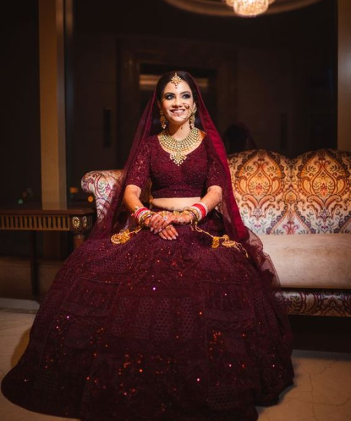 Rich maroon lehenga with layered design and subtle sequin work