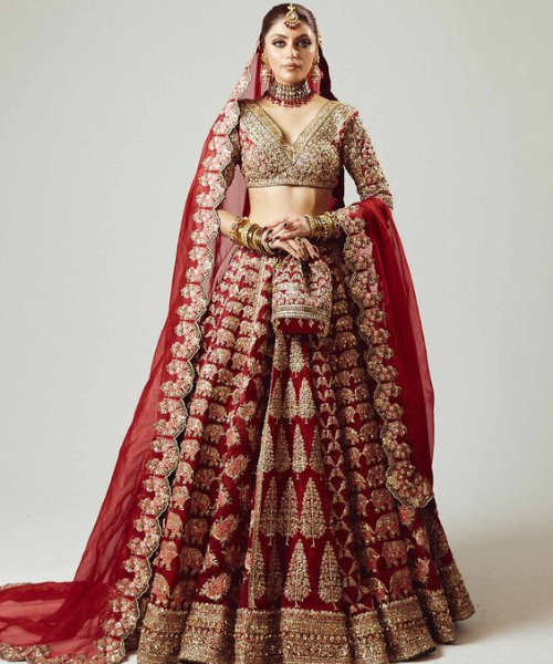 Red lehenga with intricate gold motifs and geometric patterns