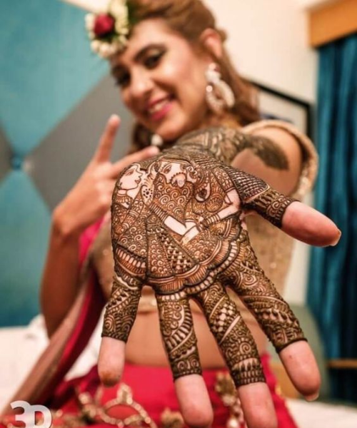 Bride pointing at the mehndi design