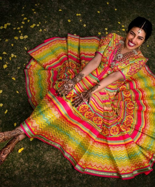 Showing hand and foot mehndi in the shot