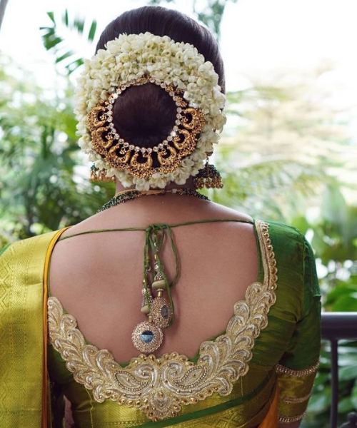 Bun with gold hair accessory and wrapped in Jasmine