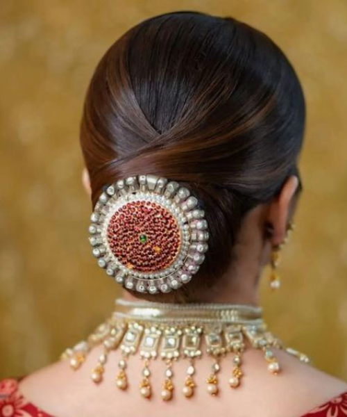 Sleek Bun with Ornate Red and Pearl Hair Accessory