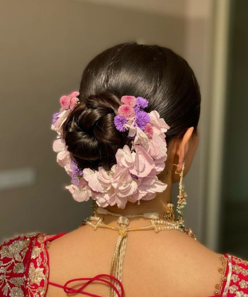 Chic Floral Adorned Bridal Bun with Purple and Pink Flower