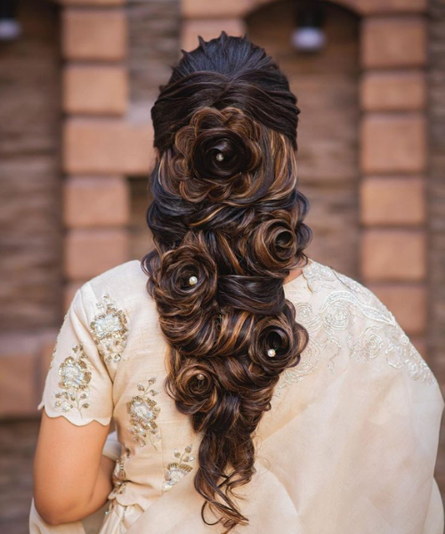 Elegant Floral Updo with Intricate Rolled Curls