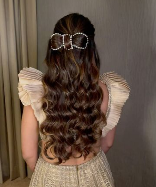 Half-Up Hairstyle with Pearl-Accented Bow and Soft Waves