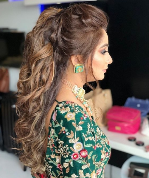 Voluminous High Ponytail with Loose Curls for a Glamorous Bridal Look