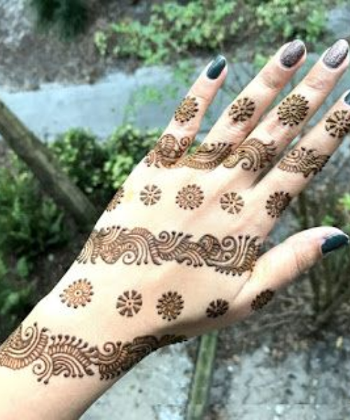 Minimalistic mehndi with dotted florals and delicate swirls