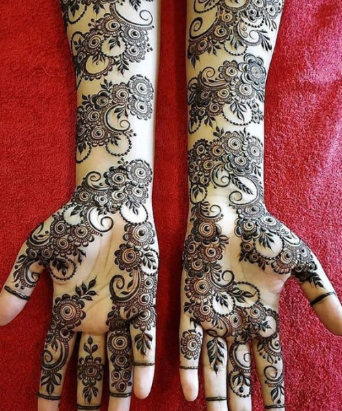 Swirling floral mehndi with circular patterns and leaf accents