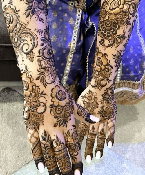 Intricate floral mehndi with paisley accents and bold finger details