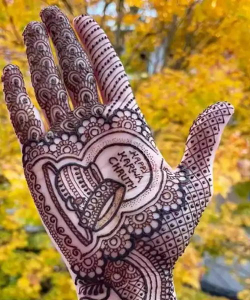 Mehndi with Happy Karwa Chauth written with related motifs