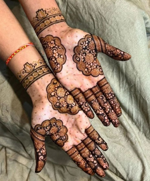 Floral mehndi with bold arches and detailed finger patterns