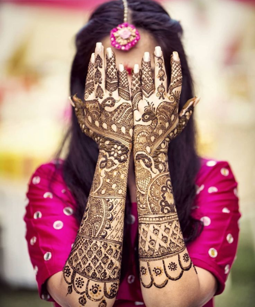 Showing mehndi while hiding her face