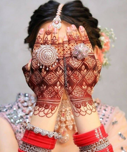 Closeup shot of mehndi while both hands in front of face