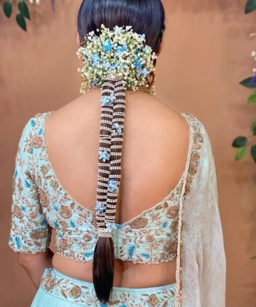 Braided hairstyle with blue flowers and silver thread