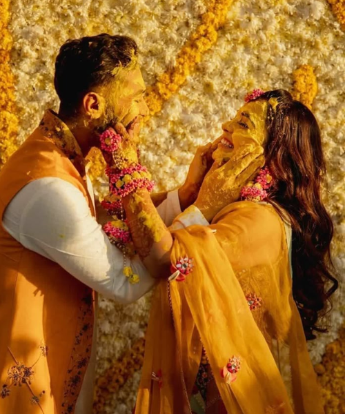 Bride and Groom applying haldi on each other - haldi function poses for brides