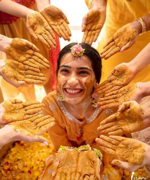 Radiant Smiles Framed by Loving Hands - Haldi Function Poses for Brides