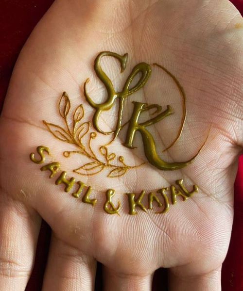 Bold Initial Mehndi with Leafy Motif Detailing