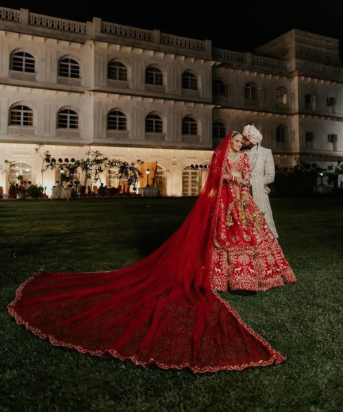 Grand Veil Trail Pose with Groom Holding Bride