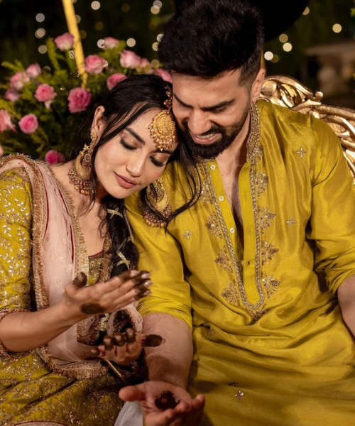 Mehndi Ceremony Pose with Bride Leaning on Groom